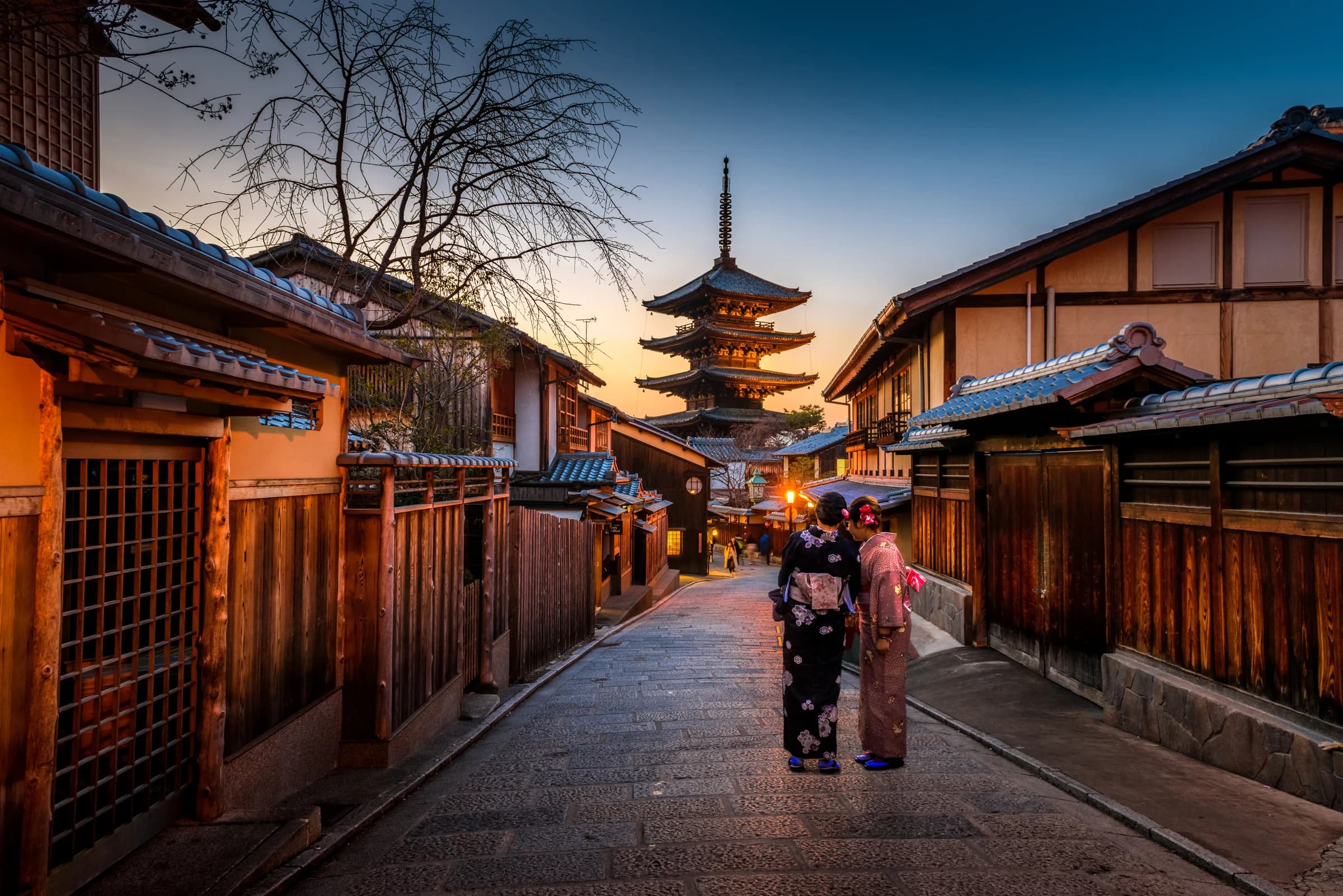 Yasaka Pagoda above a traditional wooden street in Kyoto at sunset